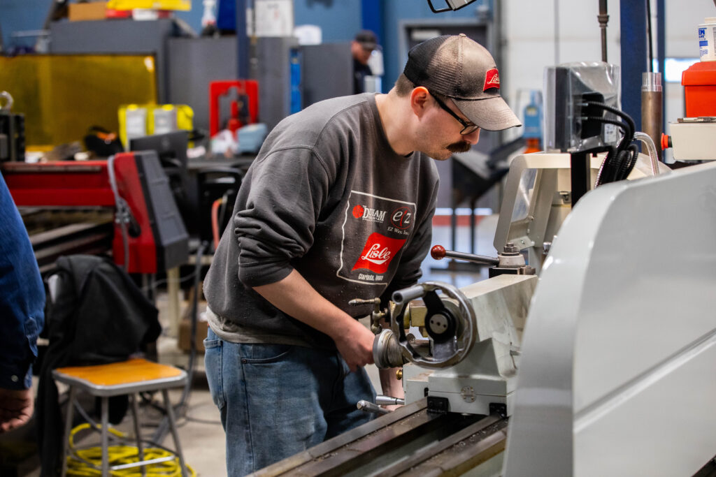 student working in the ceam building looking over a machine