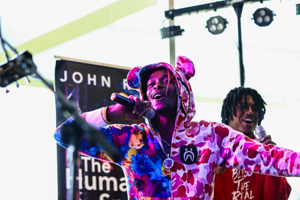 Student singing on stage, on campus