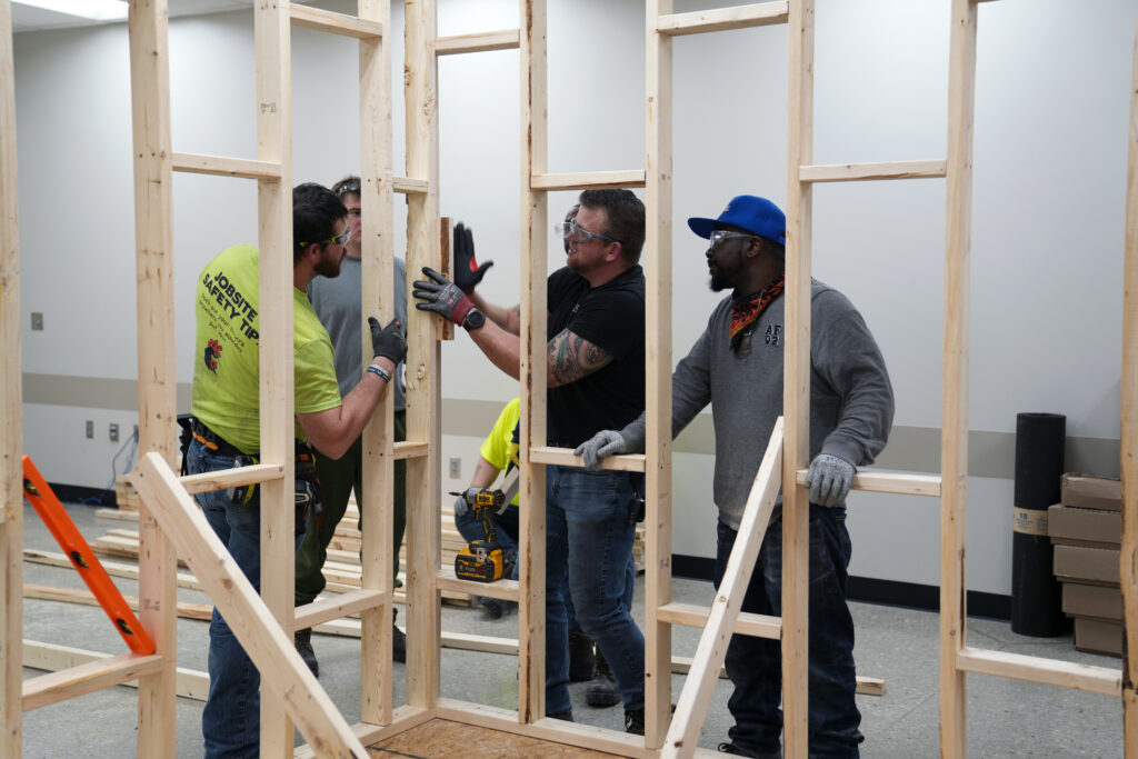 Students working together to build a frame
