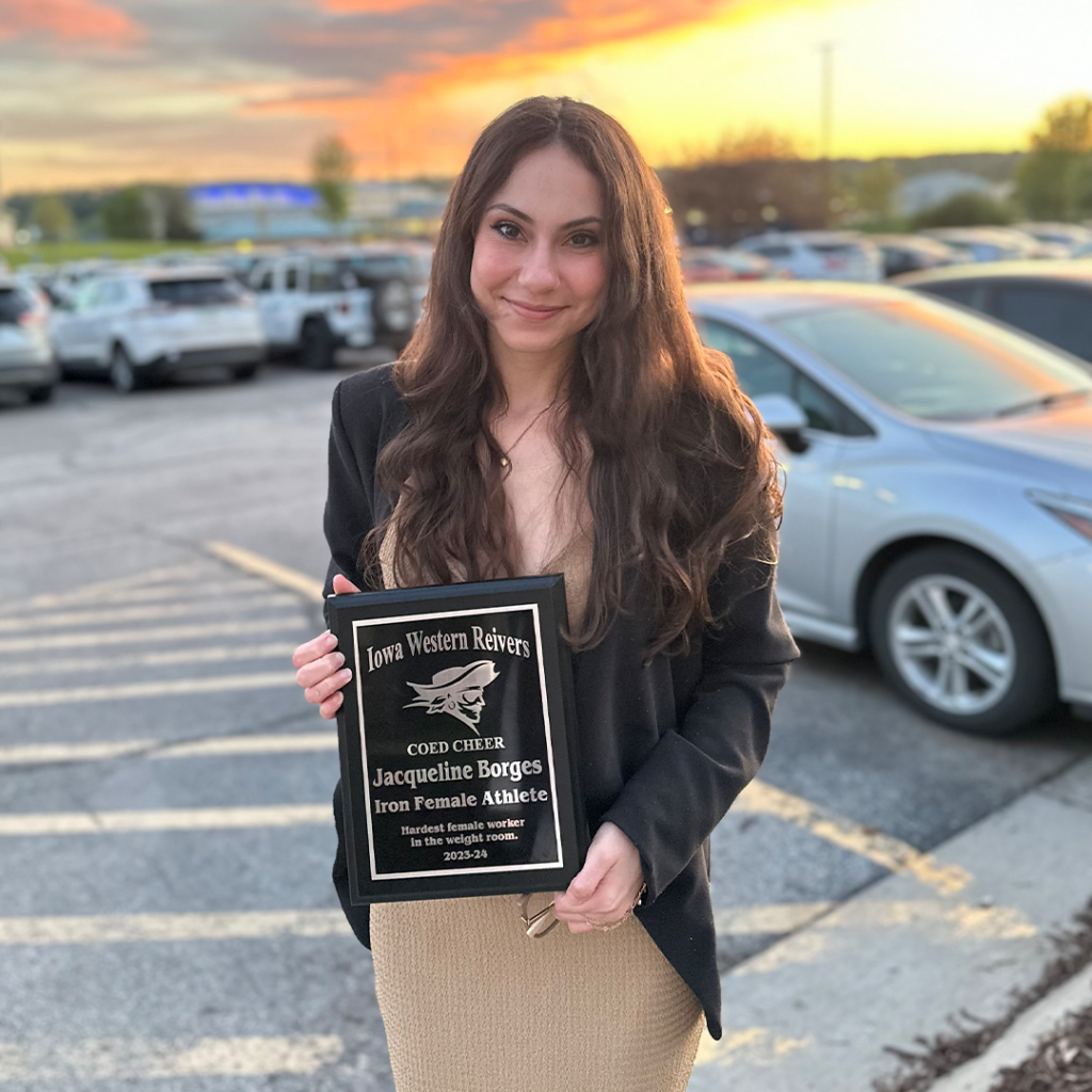 Jacqueline Borges holding her COED Cheer Iron Female Athlete award.