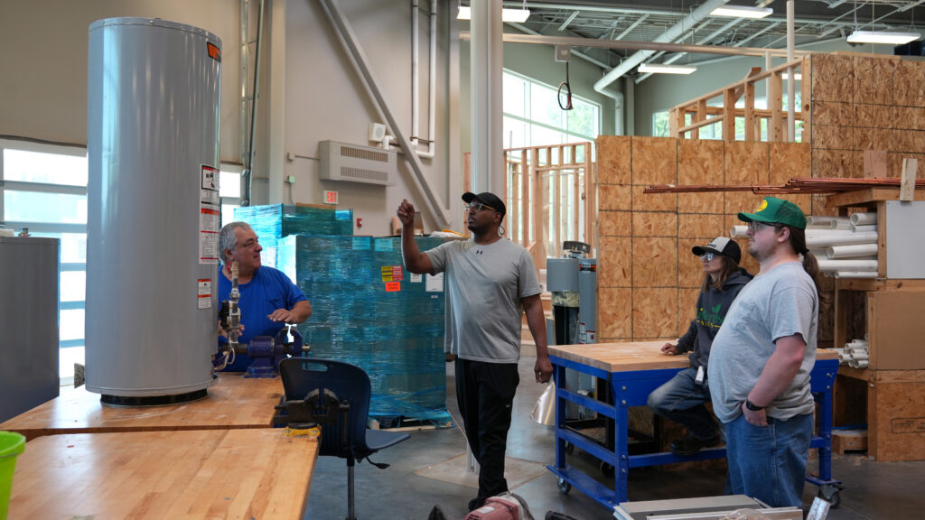 Iowa Western Students in a workshop going over plumbing